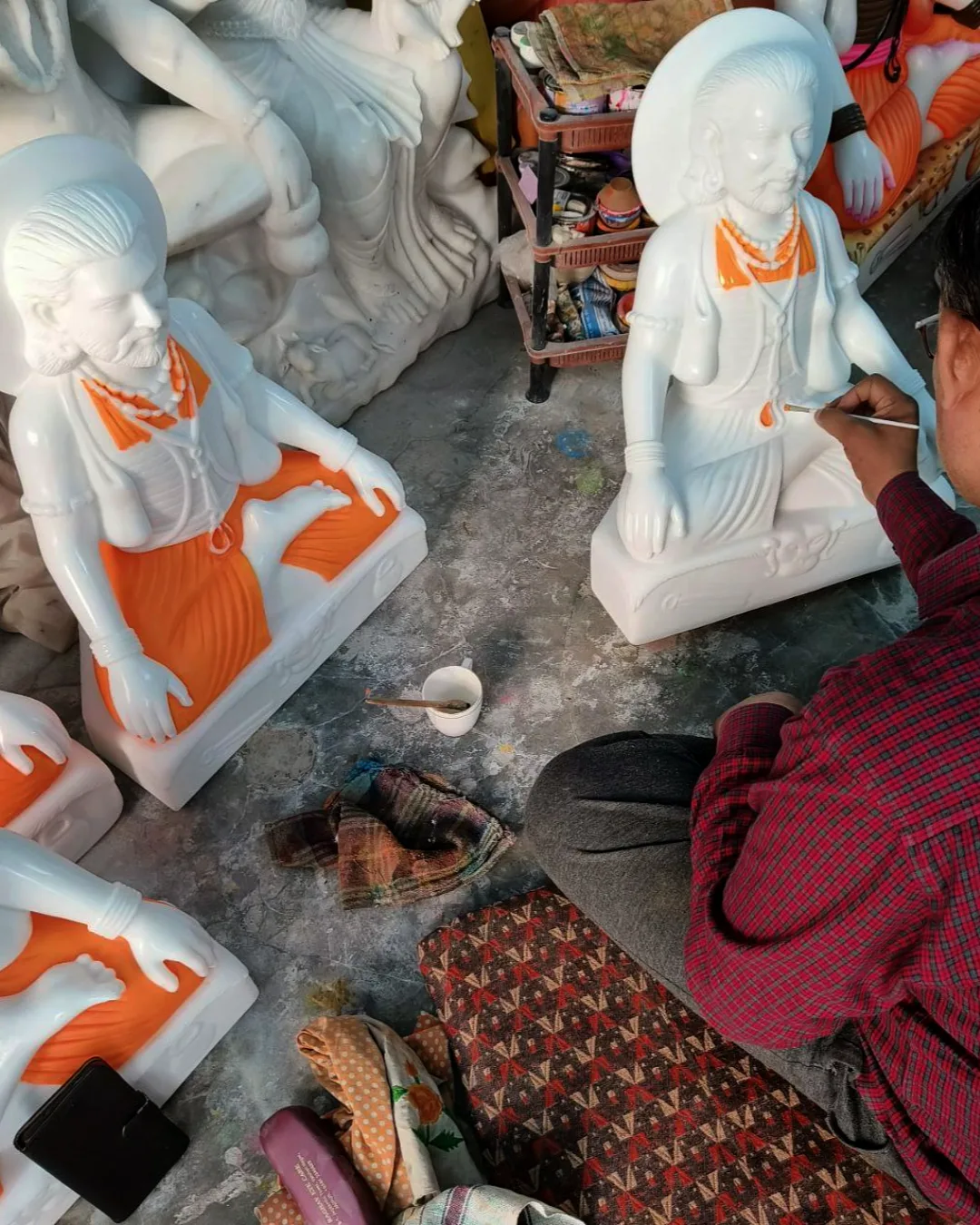Marble Sculpture Hand-Painting Process – Shilpagya Jaipur Studio Jaipur marble sculpture artisan hand-painting a saint statue in Shilpagya workshop